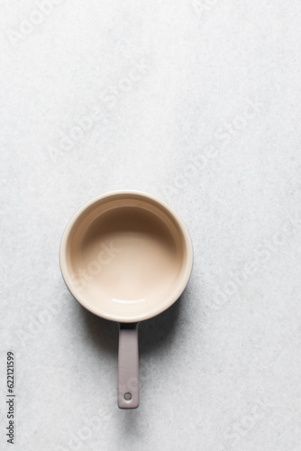 Top view of a cream and mauve ramekin with a handle, flat lay of an oven safe ramekin for baking