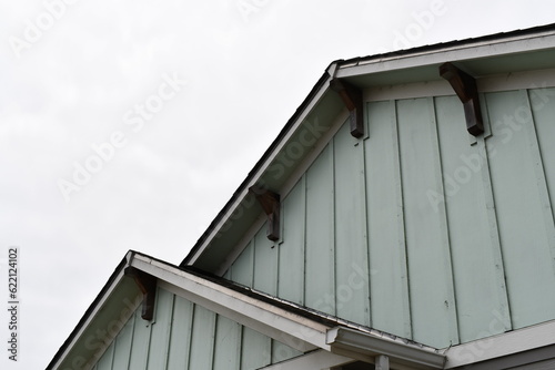 Double gabled roof line against a white sky.