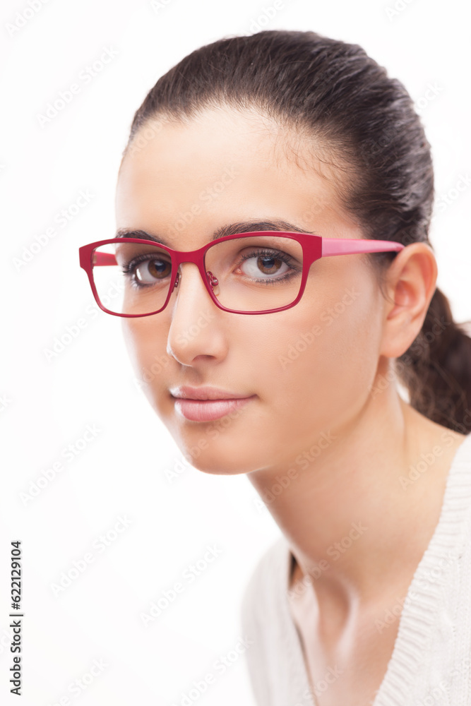 Young attractive model wearing fashion glasses and posing on white background