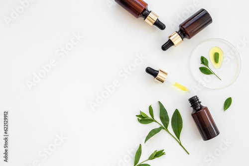 Cosmetic herbal essential serum oil in bottle with pipette