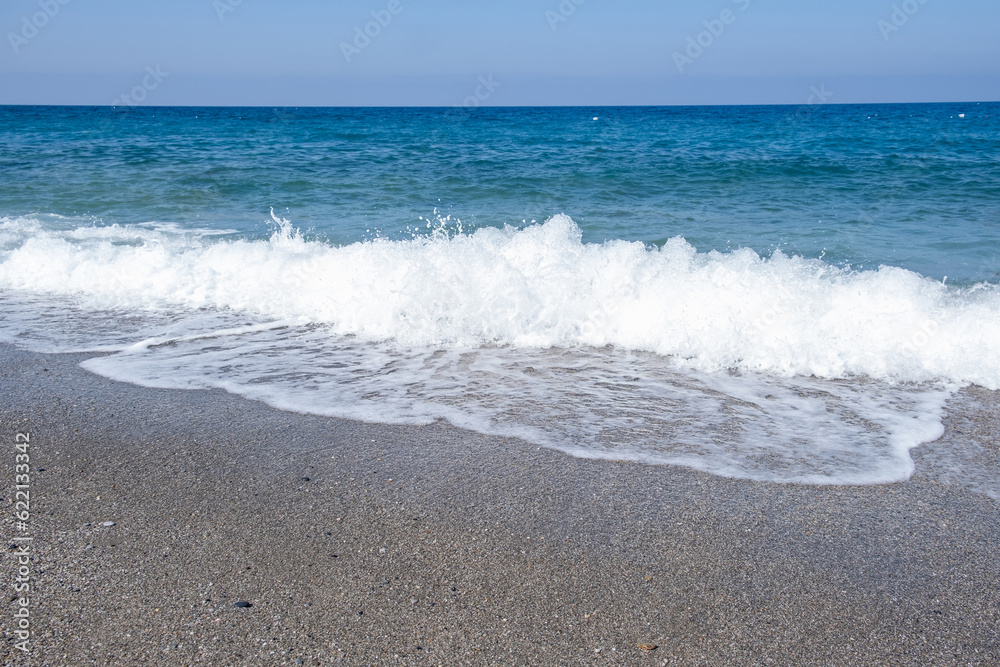 Sea waves run on the shore of the sea or ocean. Beautiful relaxing view on vacation.
