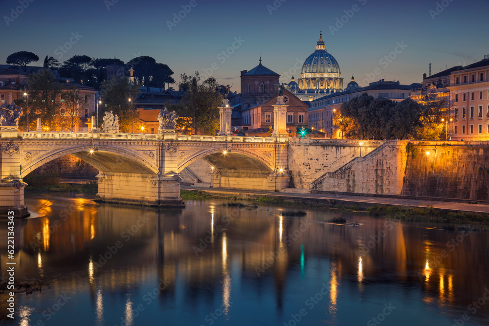 View of Vittorio Emanuele Bridge and the St. Peter's cathedral in Rome, Italy at night.