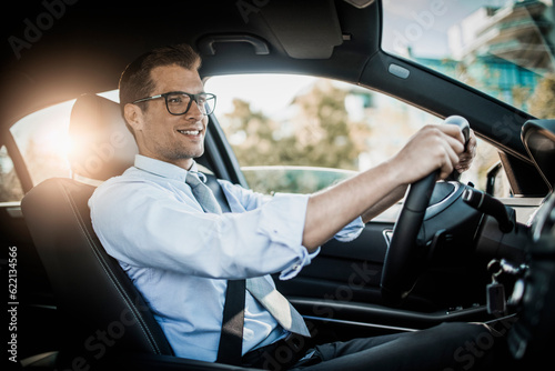 Young businessman driving a luxury car
