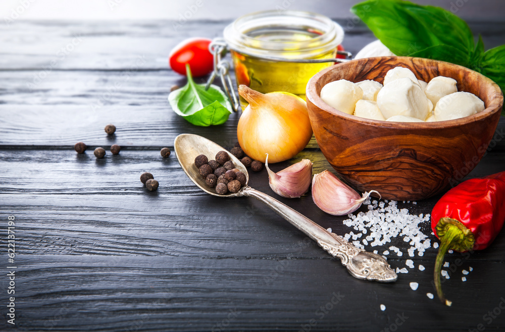 Vegetables and spices ingredient for cooking italian food on black wooden old board in rustic style Vegetables and spices ingredient for cooking italian food on black wooden old board in rustic style