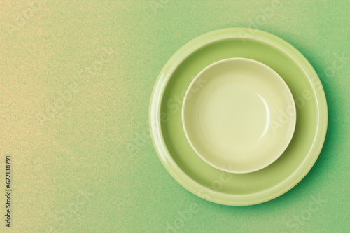 top shot green bowl and plate on yellow - green background