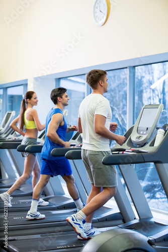 Fototapeta Naklejka Na Ścianę i Meble -  Active people on a treadmill