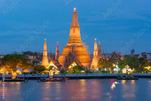 Large illuminated temple Wat Arun after sunset seen accross river Chao Phraya. Bangkok  Thailand
