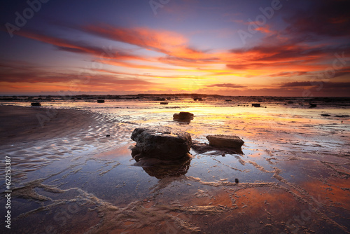 Photography Vivid sunrise and reflections across Long Reef in Sydney's Northern beaches, Aus
