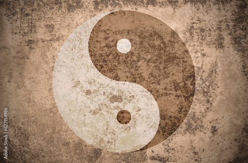 yinyang symbol on a grungy vintage texture with stains, scratches and wrinkles photo