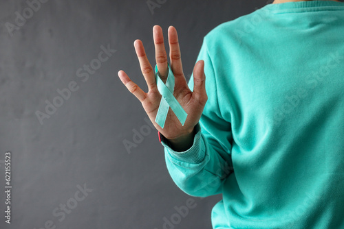 Billede på lærred Woman hands with green ribbon symbol for world mental health day, cervical, kidn