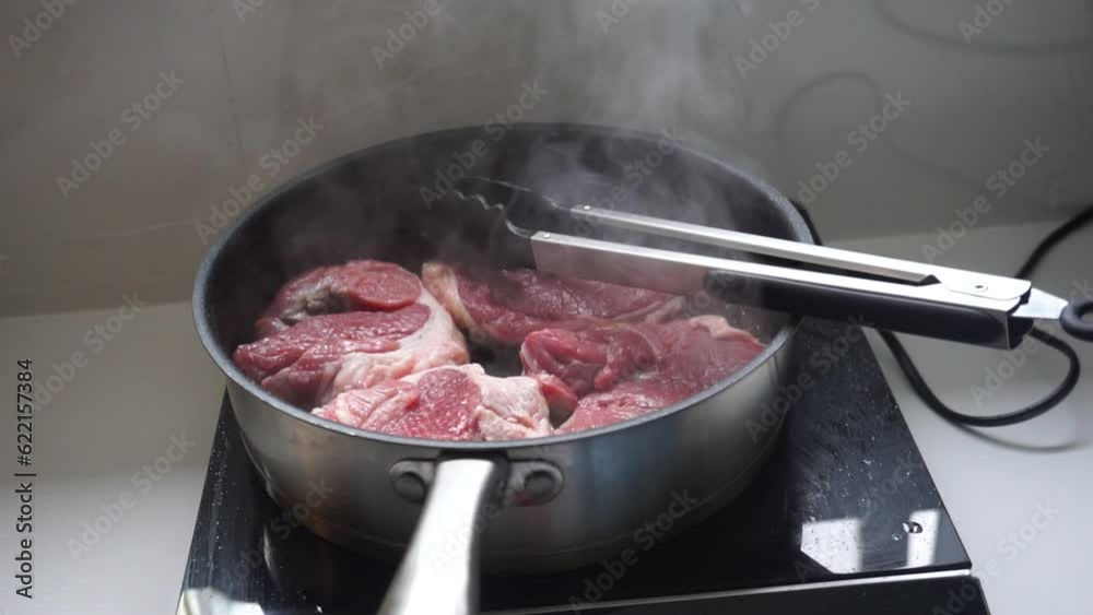beef is being cooked in a cooking pot beef is being cooked in a cooking pot