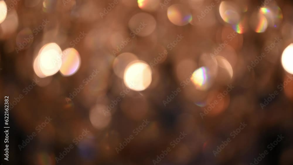 The bokeh of a crystal chandelier with crystals shimmers with bright lights. The ceiling light is brightly reflecting. Volumetric lamp with crystals rotates smoothly. The bokeh of a crystal chandelier with crystals shimmers with bright lights. The ceiling light is brightly reflecting. Volumetric lamp with crystals rotates smoothly.