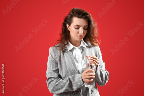 Young woman with bottle of ...