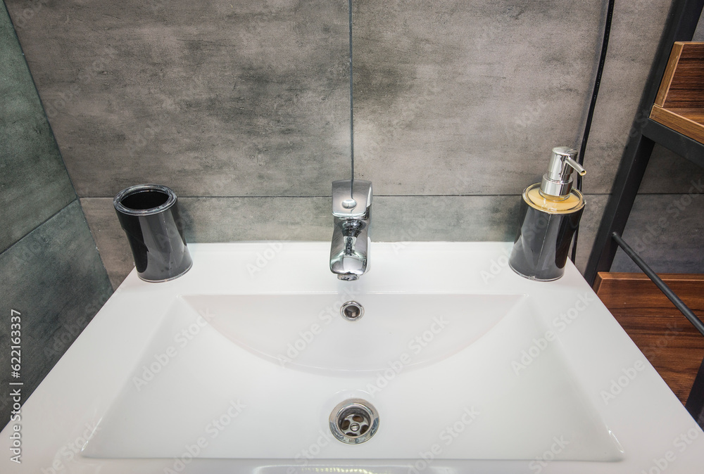 Fototapeta premium White metal sink, liquid soap dispenser, mixer tap