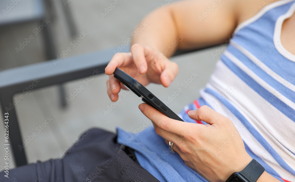 hand tightly gripping a smartphone, symbolizing the pervasive distraction of modern social media and its impact on human connection