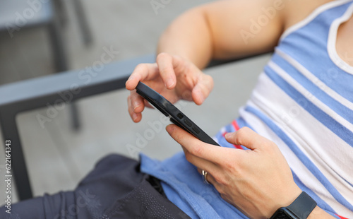 hand tightly gripping a smartphone, symbolizing the pervasive distraction of modern social media and its impact on human connection