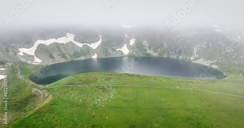 Mountain lake in fog nature of Rila mountains Bulgaria, Babreka pond, 4K video  photo