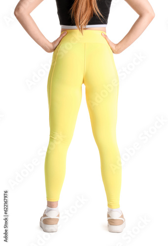 Sporty young woman in leggings on white background, back view