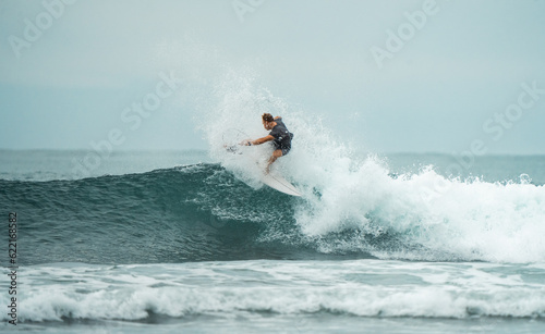 Peak Performance: Surfer Masterfully Executes a High-Intensity Turn at the Majestic Waves of Mentawai Islands, Indonesia