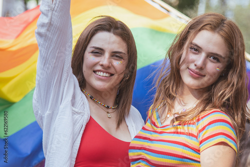 Caucasian pretty women holding a gay flag.