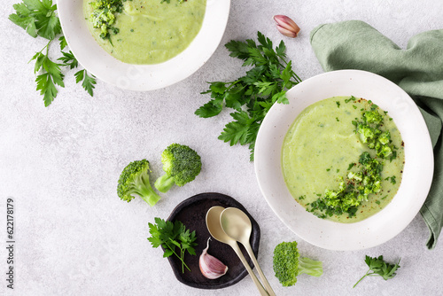 Broccoli green soup with fresh parsley. Healthy and diet vegan dish. Top view on stone table.