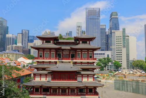 awe-inspiring aerial view showcases Buddha Tooth Relic Temple, a magnificent Buddhist temple nestled in Singapore's vibrant Chinatown district. Against the bustling business district skyline