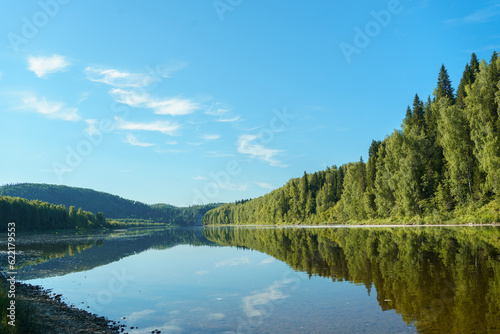 Landscape of the river in summer. Clear blue sky  reflection of the sky in the water. Peace and quiet. The concept of tourism and recreation. Vishera river rafting  nature of the North. High quality