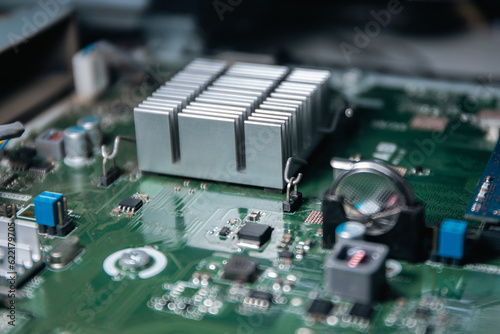 CMOS backup battery CR2032,Pci-express,SATA Port, circuit on a modern black motherbord. Computer mainboard circuit components. Desktop PC hardware components. Close-up.