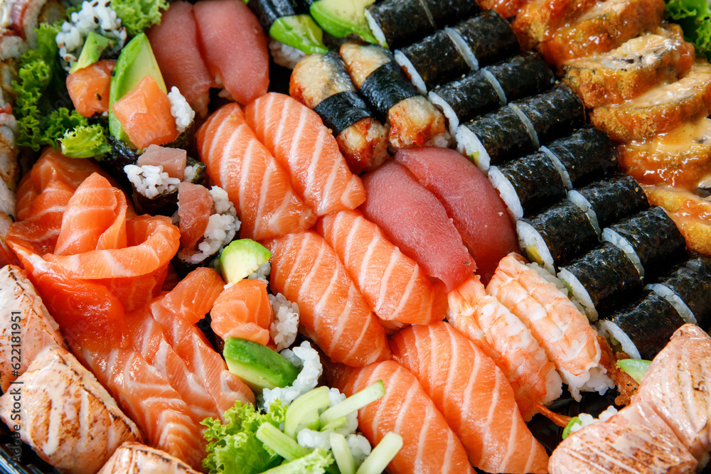 Assorted Sushi Nigiri and Maki Big Set on Slate. A Variety of Japanese Sushi with Tuna, Crab, Salmon, Eel, and Rolls. Top View. Assorted Sushi Nigiri and Maki Big Set on Slate. A Variety of Japanese Sushi with Tuna, Crab, Salmon, Eel, and Rolls. Top View.