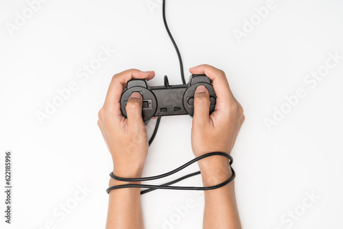 Video Game Addiction. Wire and gamepad or joystick, wired hands with joypad meaning