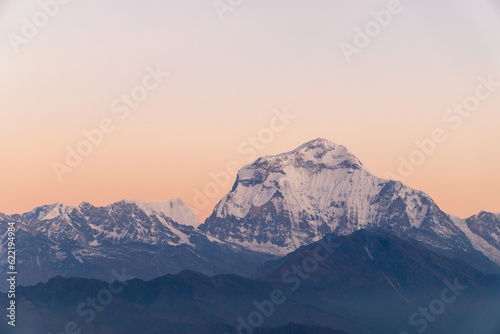 Machhapuchhre Peak  the sunrise area of annapurna base camp  Nepal  is a very beautiful peak of the Himalayas. snow capped peaks photo from a distance The red-orange morning sun shines brightly.