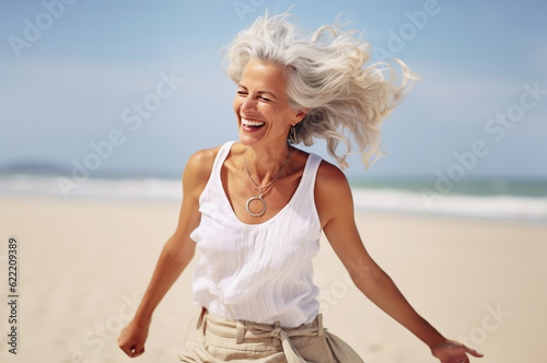 Obraz na plátně AI generated image of happy dancing mature woman at the beach