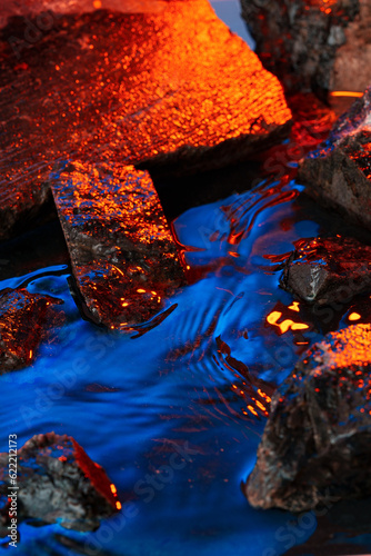 Stones and water illuminated by colored light