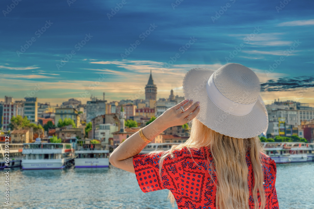 Tourist girl watching Galata Tower and buildings around, Istanbul, Turkey
