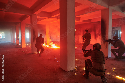  A group of professional soldiers bravely executes a dangerous rescue mission, surrounded by fire in a perilous building.