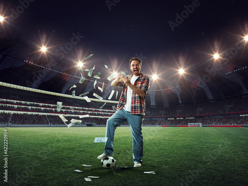Photography Young man standing on 3D football stadium and celebrate winning of many money