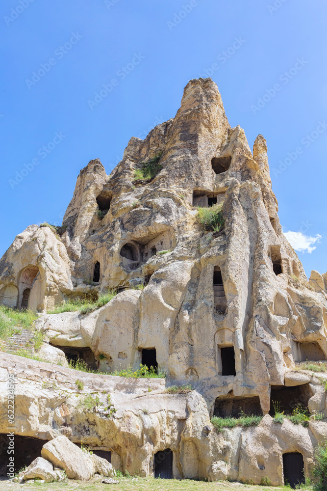 Cave medieval monastery. Rock with many caves. Goreme Open Air museum. Vertical shot. Cappadocia, Turkey