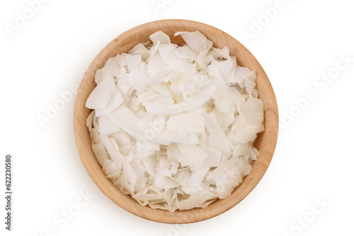 Coconut flakes or chips in wooden bowl isolated on white background. Top view. Flat lay