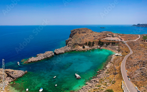 Aerial birds eye view drone photo Saint Paul bay near village Lindos, Rhodes island, Dodecanese, Greece. Sunny panorama with lagoon and clear blue water. Famous tourist destination in South Europe