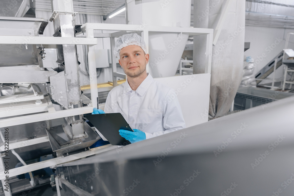 Worker man control quality product on automatic conveyor belt for transporting wheat mill. Concept modern food industry, factory production line Worker man control quality product on automatic conveyor belt for transporting wheat mill. Concept modern food industry, factory production line