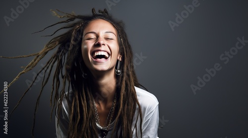 Foto Happy woman with dreadlocks smiling cheerfully in a studio at white background,