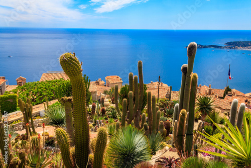 Scenic view of the Mediterranean coastline, medieval houses and exotic garden from the top of the medieval village of Eze village on the French Riviera