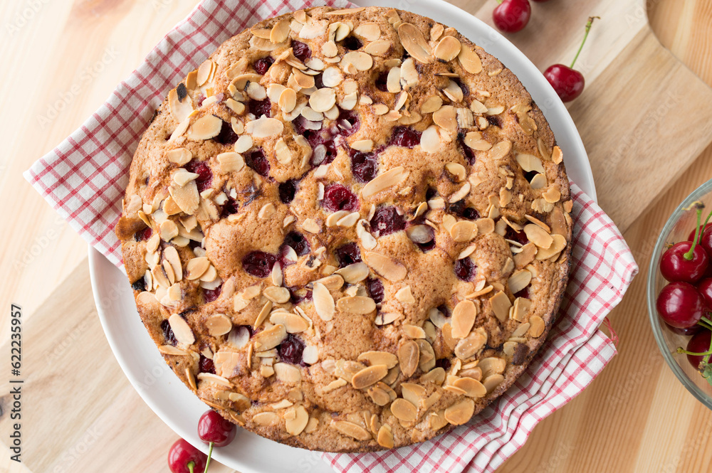 Homemade cherry pie with almonds and sour cherries on a wooden table Homemade cherry pie with almonds and sour cherries on a wooden table