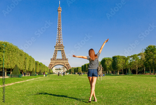 Tourist woman and Eiffel tower in Paris, France, Europe in summer