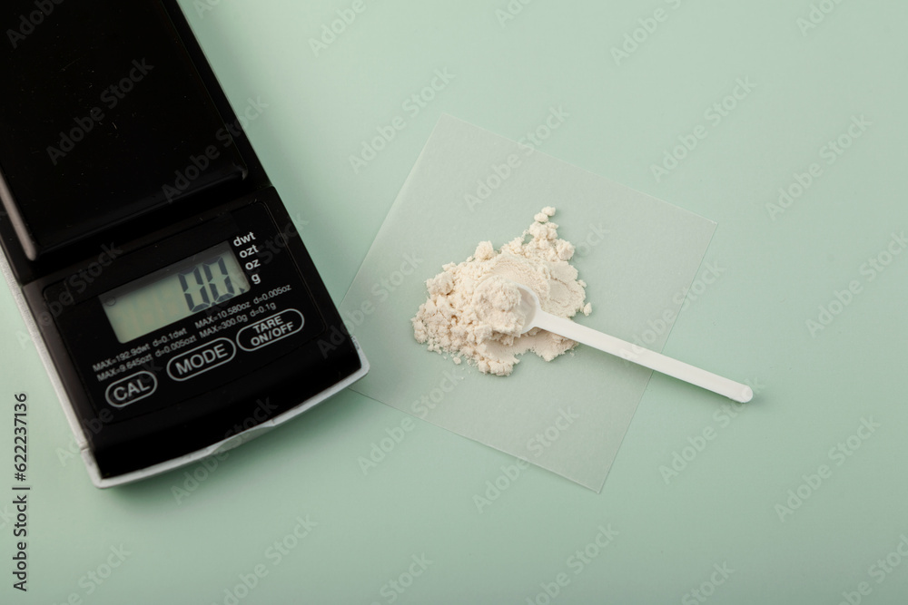 Measuring spoon and Guar gum powder or guaran. Food additive E412