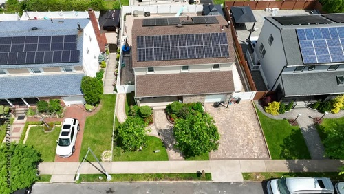 Aerial Birds Eye shot of modern Rooftop Solar Panels On Home In American Neighborhood. Green renewable energy concept