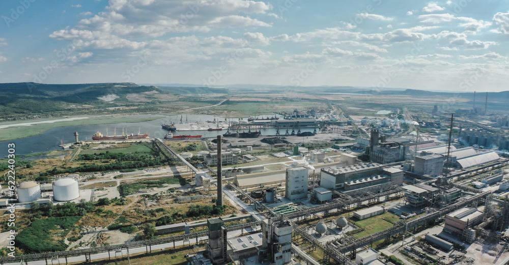 carbon footprint. Close up Aerial Industrial zone in Europe with smoke is poured from the factory pipe. Pollution of the environment. Anamorphic scope 2.39 ratio