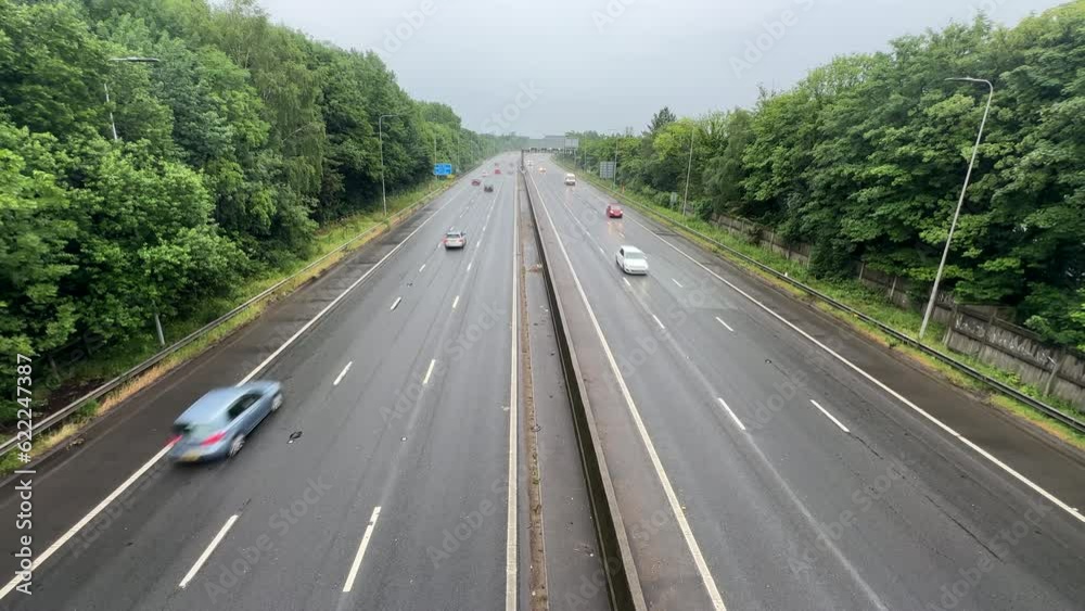 High angle view of motorway or highway traffic on a rainy summer day, time lapse. High angle view of motorway or highway traffic on a rainy summer day, time lapse.