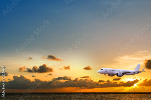Commercial airplane above sea with sunset in summer season over beautiful scenery ocean background, Concept business travel and transportation summer vacation travel.