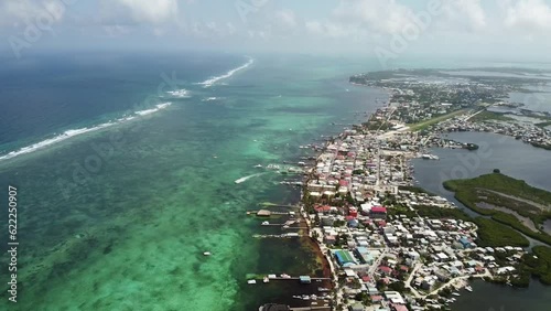 Aerial view of the city of San Pedro, Belize and the clear ocean, drone tilt forward photo